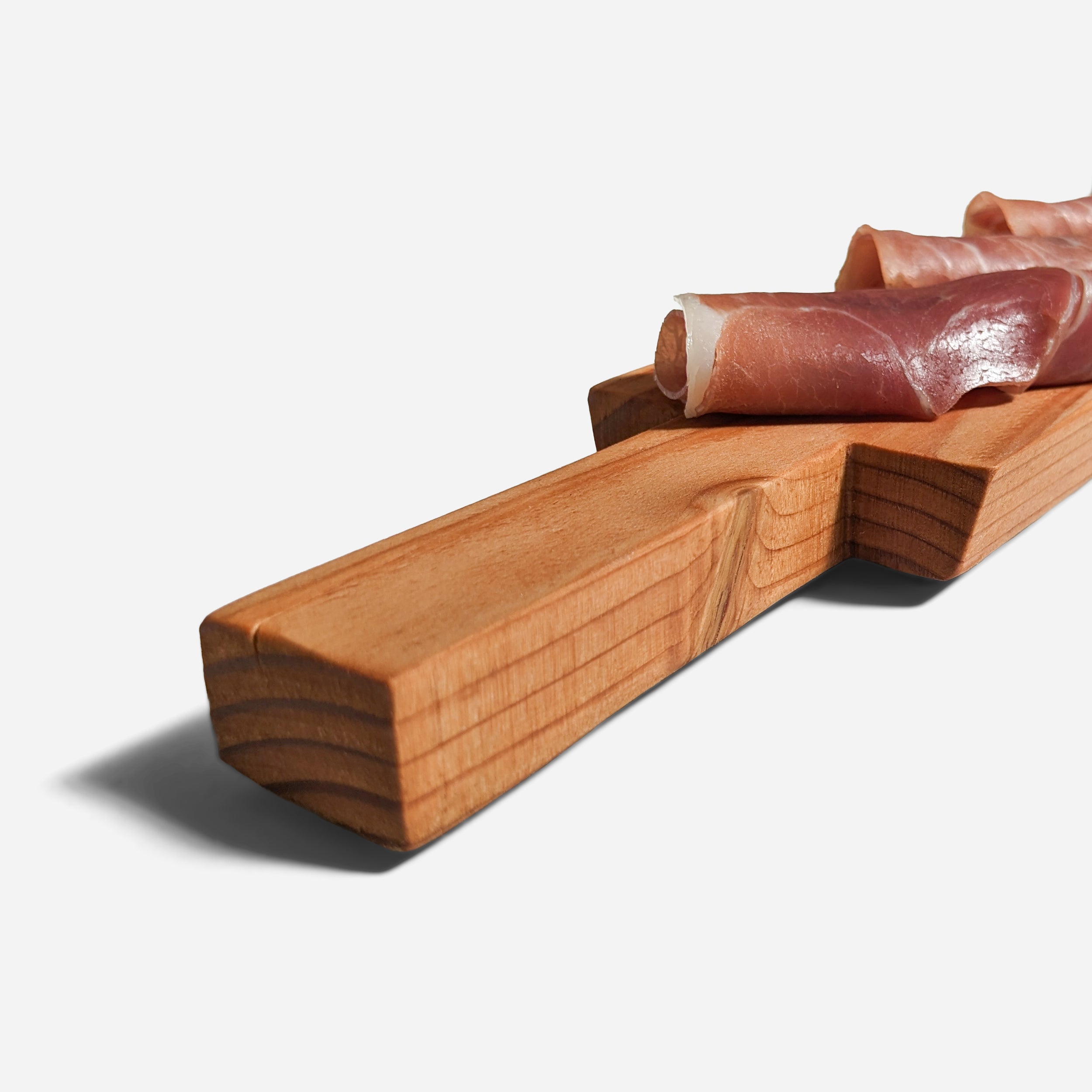 Appy charcuterie board with built-in handle, showcasing natural wood grain and sleek design, perfect for serving appetizers.