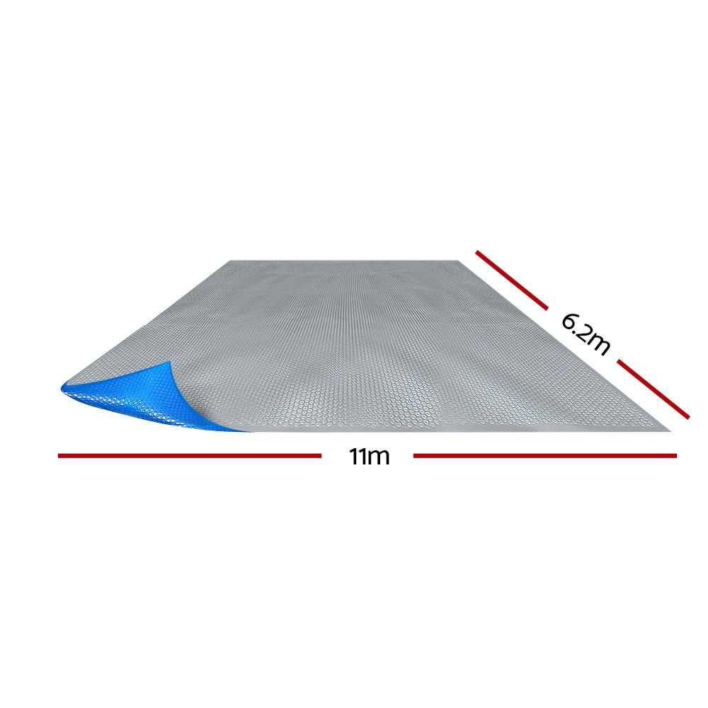 Aquabuddy 11X6.2M Solar Swimming Pool Cover Blanket featuring a blue top and silver underside, designed for heat retention and debris prevention.