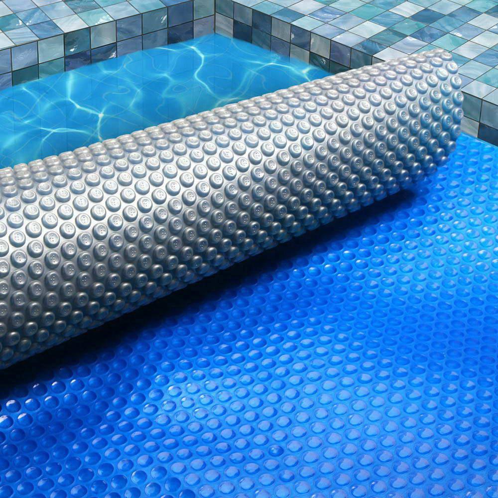 Aquabuddy Solar Swimming Pool Cover 7m x 4m with blue top and silver underside, designed for heat retention and debris prevention.