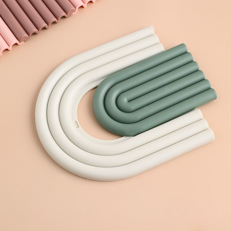 Colorful Arch Silicone Table Mat designed for heat insulation and surface protection, featuring a vibrant rainbow shape.