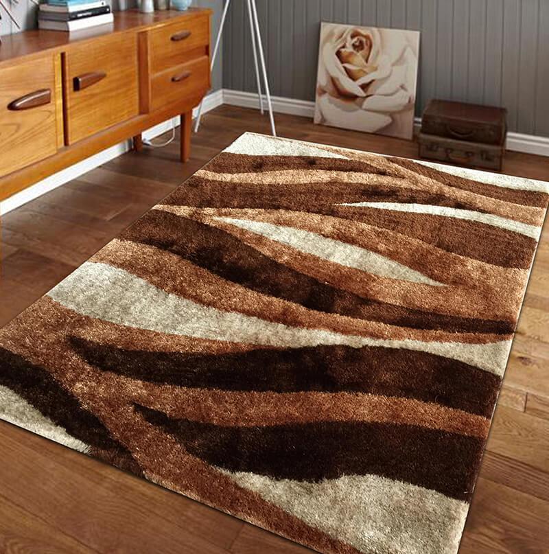 Aria Beige & Brown Soft Pile Shaggy Area Rug displayed in a cozy living room setting, showcasing its plush texture and modern design.