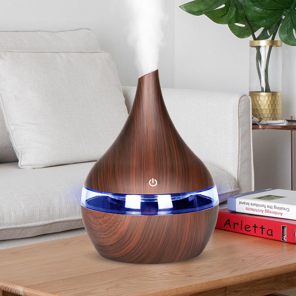 Aroma Essential Oil Diffuser in wood grain finish, showcasing its elegant design and LED lights.