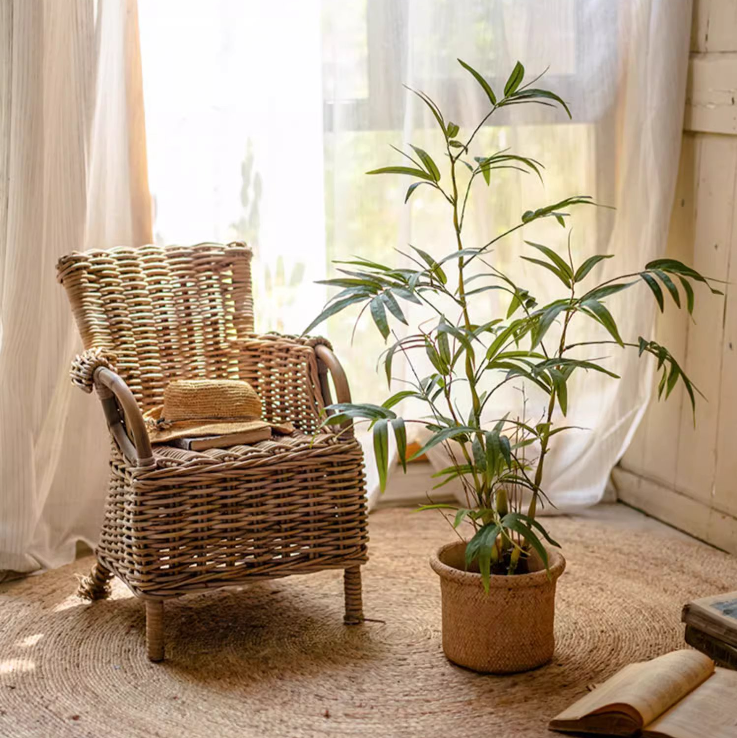 Lifelike artificial bamboo leaves in a black pot, showcasing vibrant green foliage.