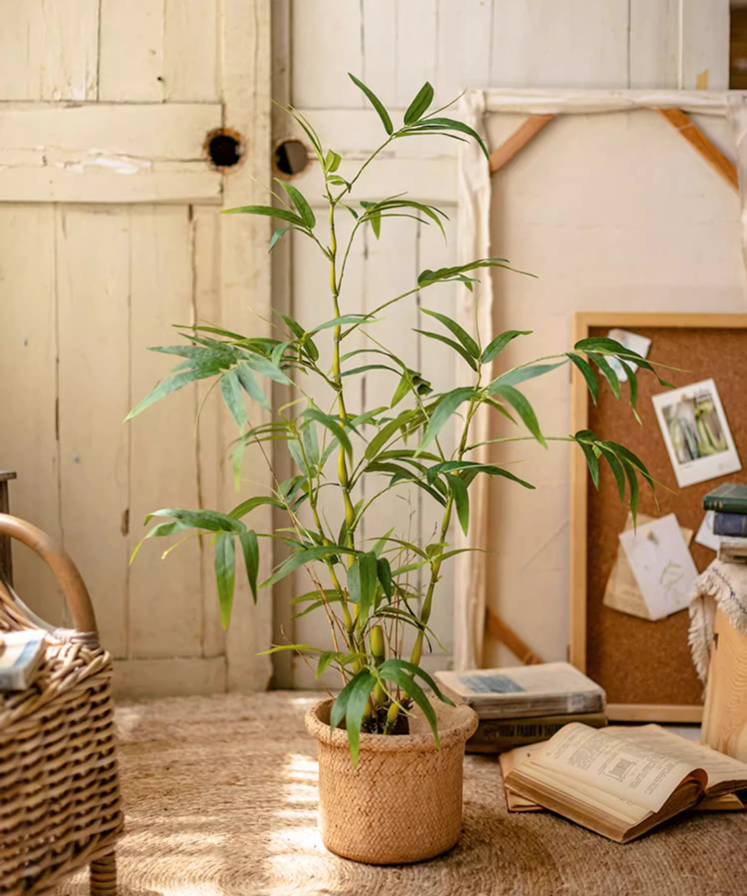 Lifelike artificial bamboo leaves in a black pot, showcasing vibrant green foliage.