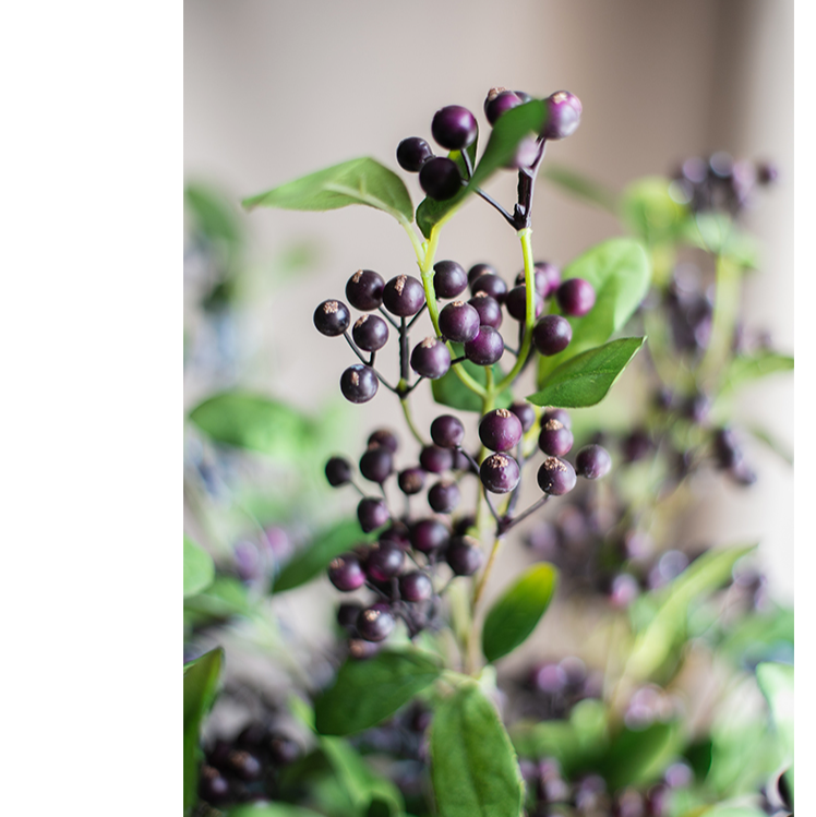 Artificial Blue Snowberry Leaf Stem, 28 inches tall with dark purple berries and green leaves, perfect for home decor.