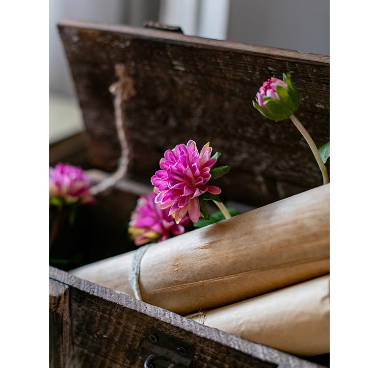 A long artificial chrysanthemum flower vine in rose color with green leaves, showcasing realistic silk flowers.