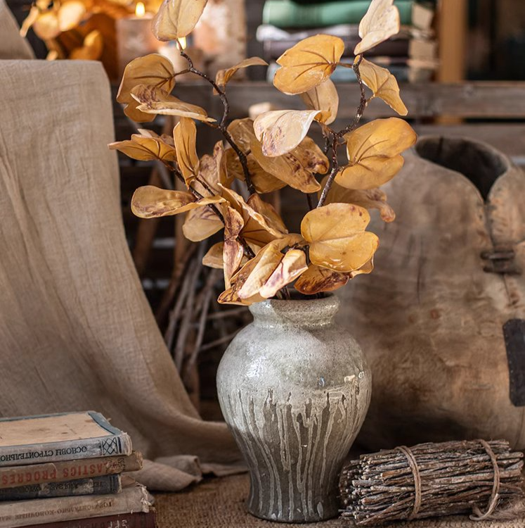 A 33-inch tall artificial dry apple leaf stem in natural yellow color, showcasing realistic leaves made of plastic and silk cloth.