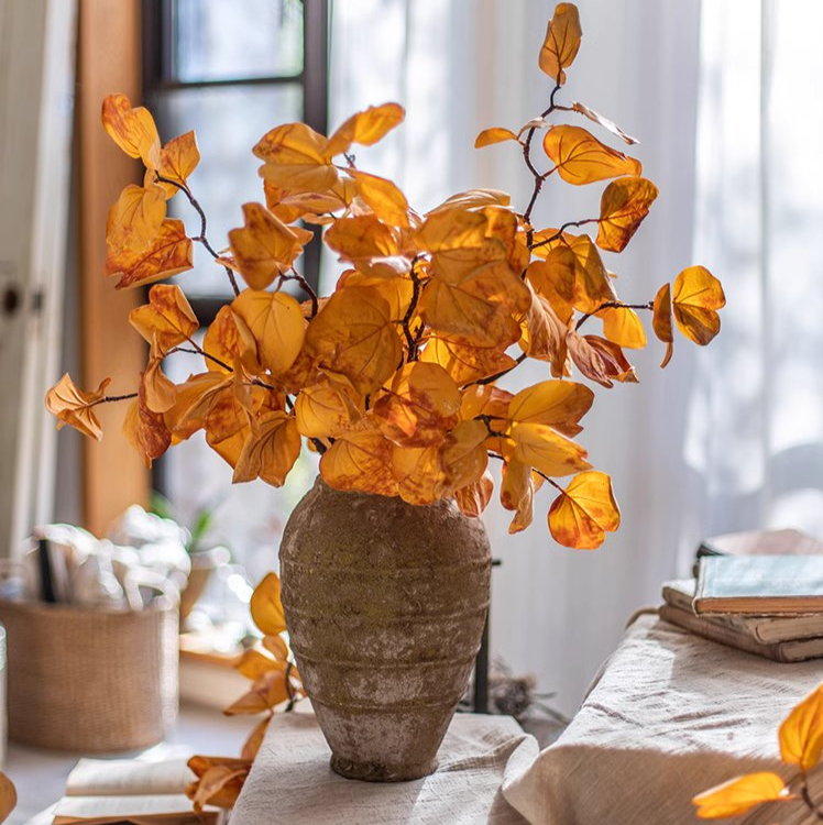 A 33-inch tall artificial dry apple leaf stem in natural yellow color, showcasing realistic leaves made of plastic and silk cloth.