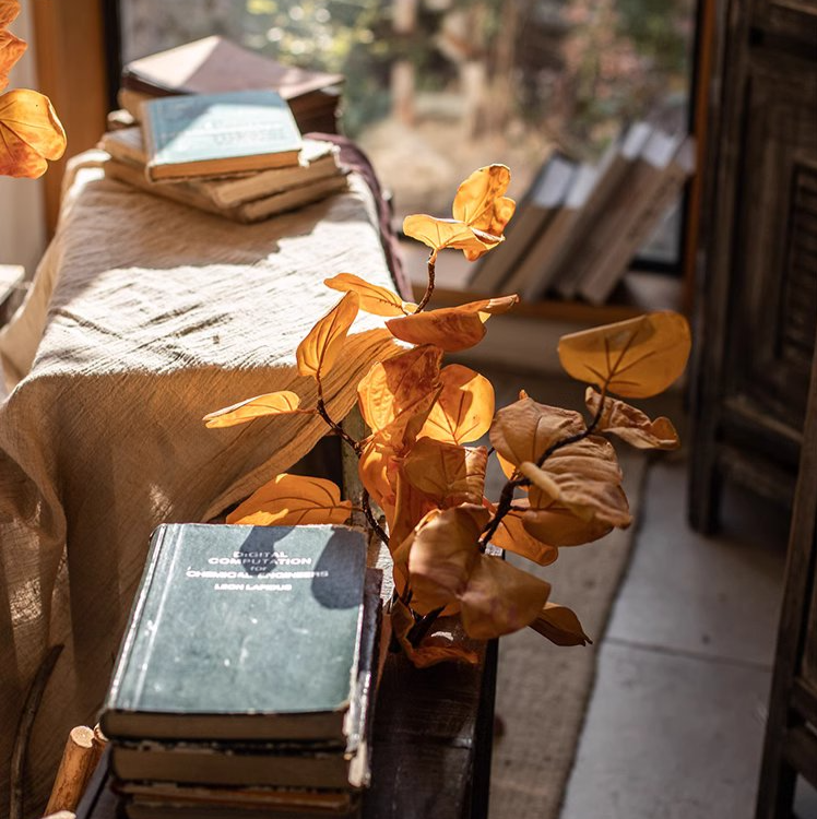 A 33-inch tall artificial dry apple leaf stem in natural yellow color, showcasing realistic leaves made of plastic and silk cloth.