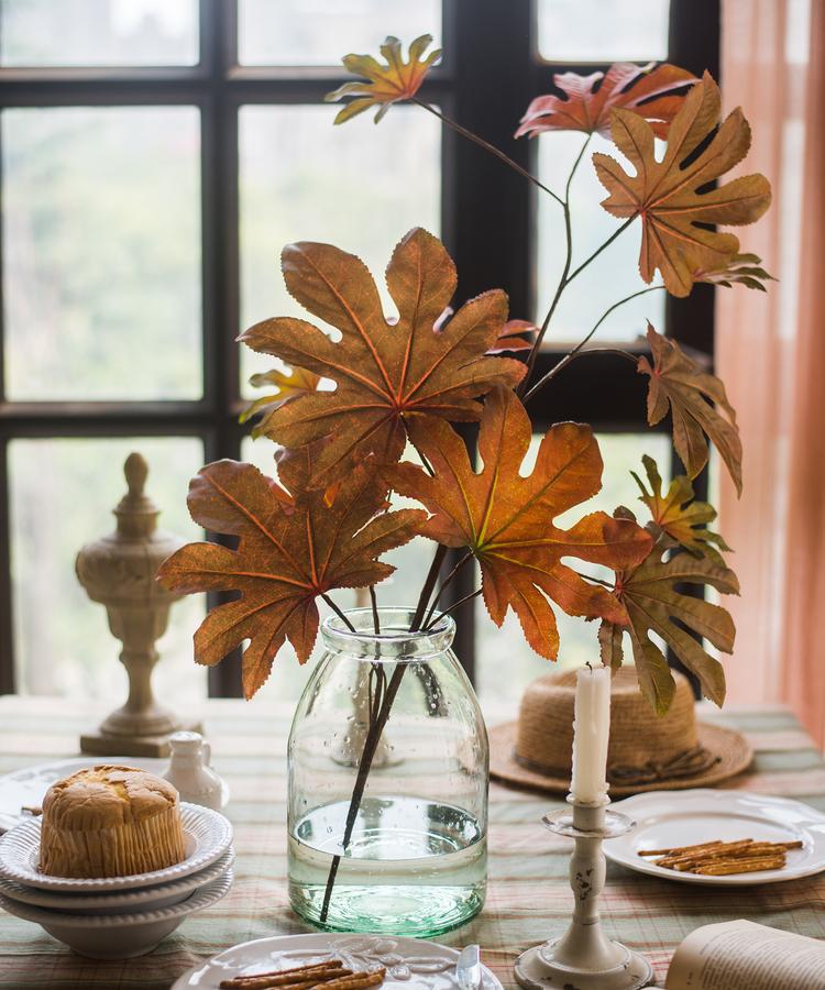 32-inch tall Artificial Fatsia Leaf in vibrant autumn red, showcasing realistic leaves and mixed colors, perfect for home decor.