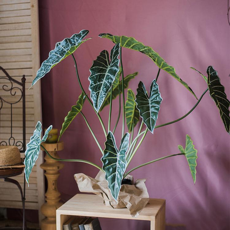 A 31-inch tall artificial Alocasia plant in a black pot, showcasing realistic green leaves and a vibrant appearance.