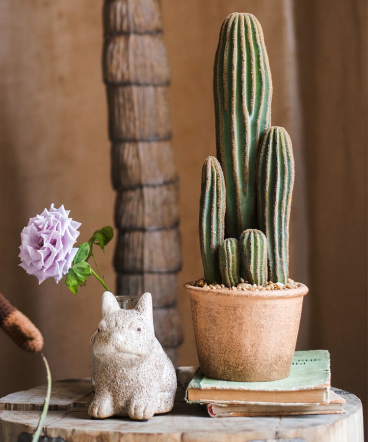 Artificial faux cactus in a brown pot, showcasing realistic green textures and earthy tones, perfect for home or office decor.