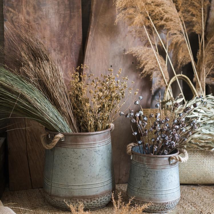 A bundle of artificial faux dried grass in green and khaki colors, showcasing its realistic texture and natural appearance.