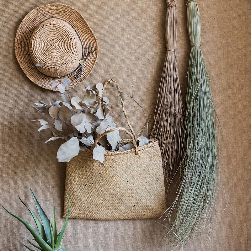 A bundle of artificial faux dried grass in green and khaki colors, showcasing its realistic texture and natural appearance.