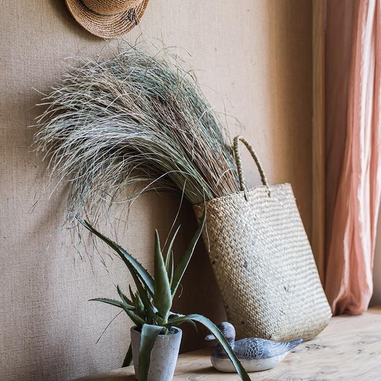 A bundle of artificial faux dried grass in green and khaki colors, showcasing its realistic texture and natural appearance.