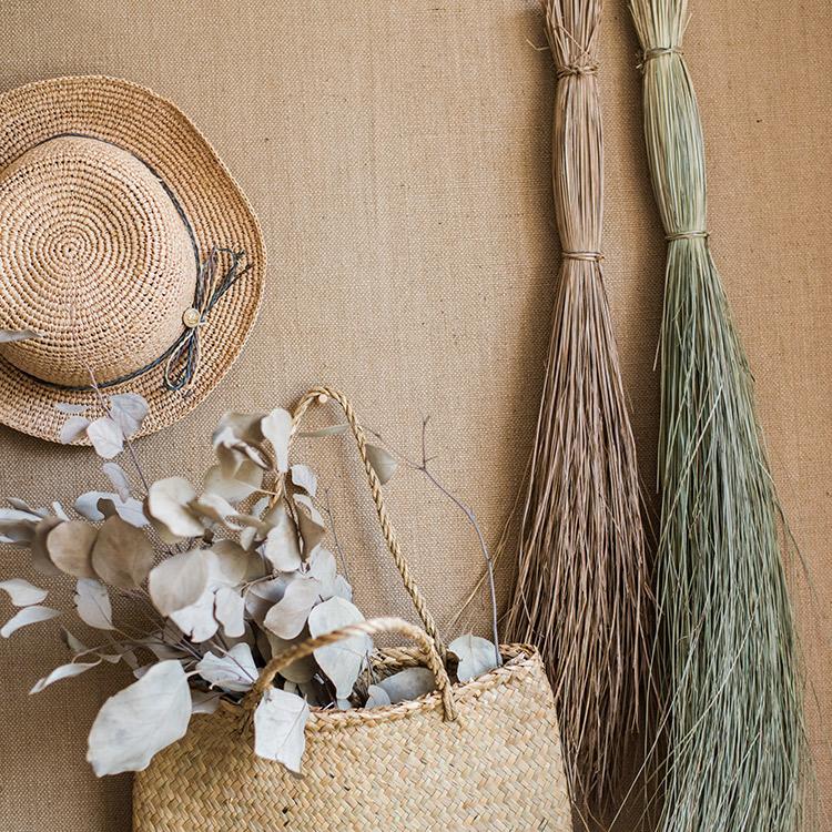 A bundle of artificial faux dried grass in green and khaki colors, showcasing its realistic texture and natural appearance.