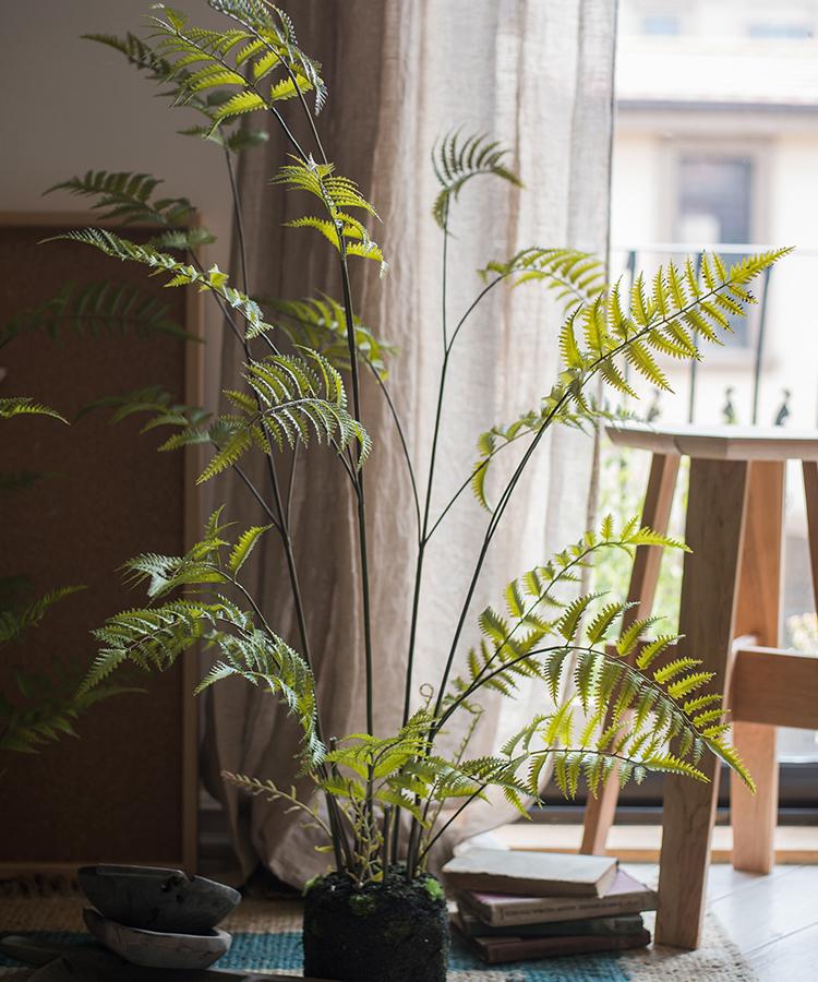 Artificial Faux Eagle Fern Bulk Plant in vibrant green with a sturdy black base, showcasing realistic leaves and textures.