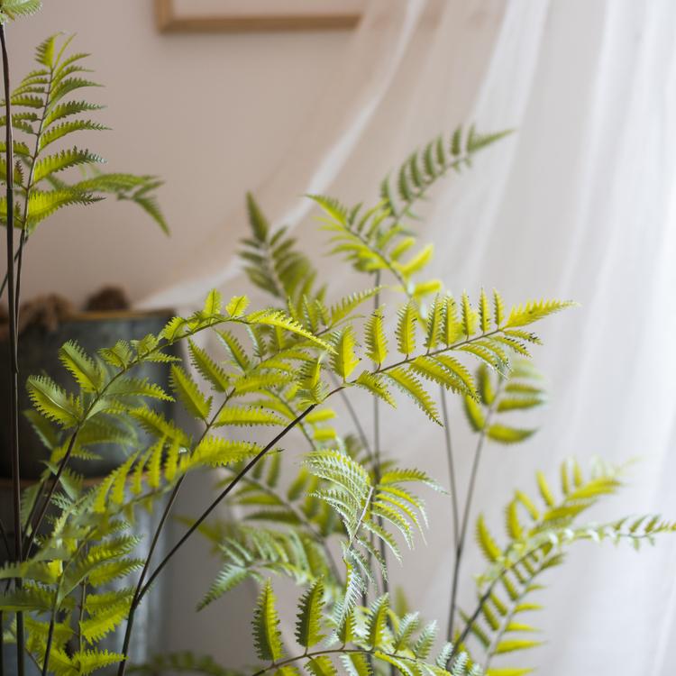 Artificial Faux Eagle Fern Bulk Plant in vibrant green with a sturdy black base, showcasing realistic leaves and textures.