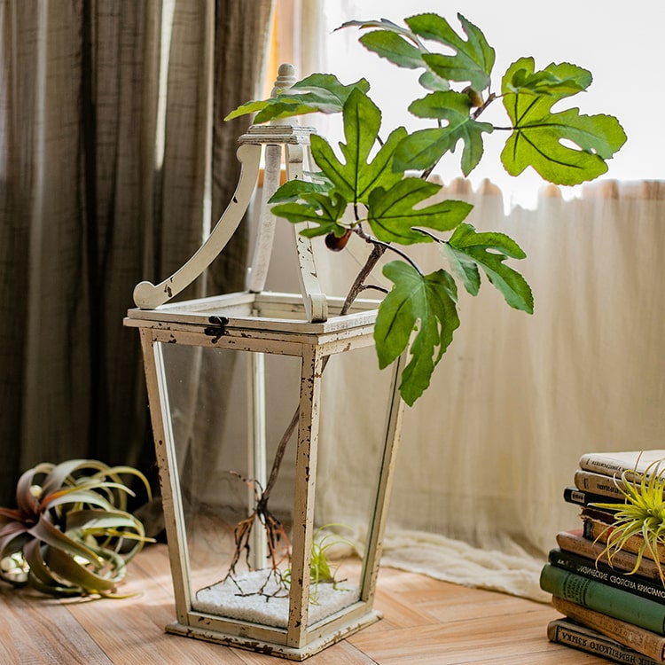 A tall Artificial Faux Fig Leaf Stem with lush green leaves, showcasing its realistic design and vibrant colors, perfect for home decor.