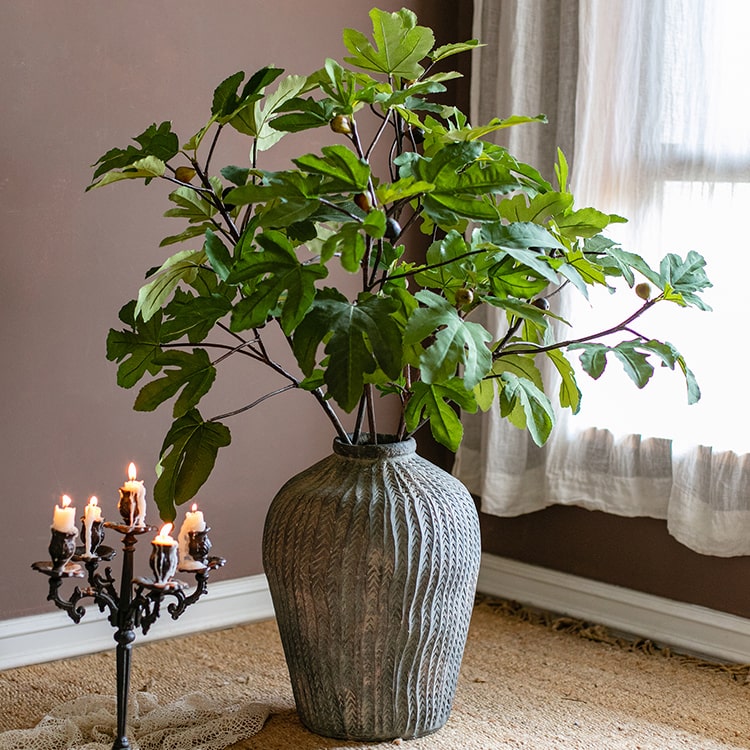 A tall Artificial Faux Fig Leaf Stem with lush green leaves, showcasing its realistic design and vibrant colors, perfect for home decor.