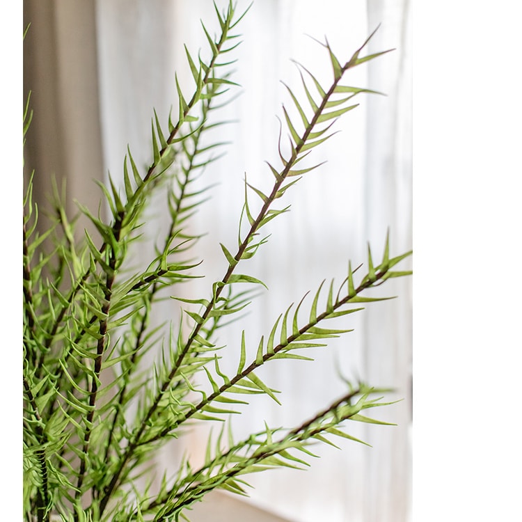 A tall 48-inch artificial faux flax grass stem in vibrant green, showcasing realistic leaves and stems, perfect for home or office decor.