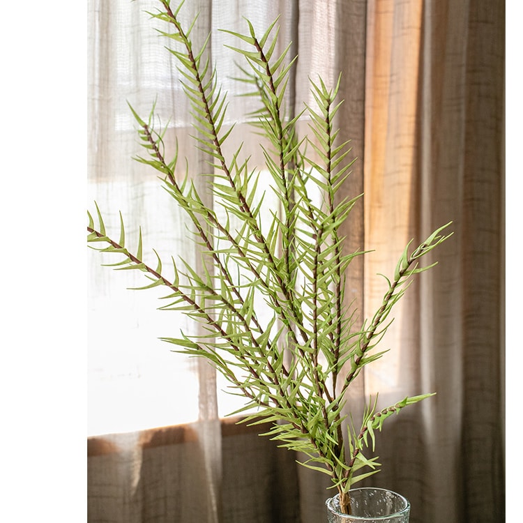 A tall 48-inch artificial faux flax grass stem in vibrant green, showcasing realistic leaves and stems, perfect for home or office decor.