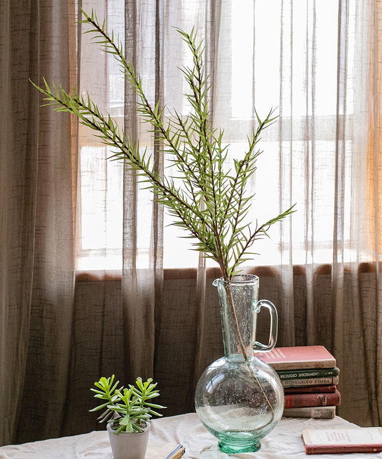 A tall 48-inch artificial faux flax grass stem in vibrant green, showcasing realistic leaves and stems, perfect for home or office decor.