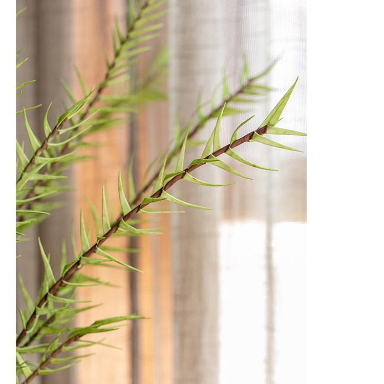 A tall 48-inch artificial faux flax grass stem in vibrant green, showcasing realistic leaves and stems, perfect for home or office decor.