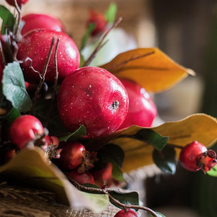 A vibrant 12-inch tall artificial bouquet featuring faux apples and pomegranates in red and green colors, perfect for home decor.