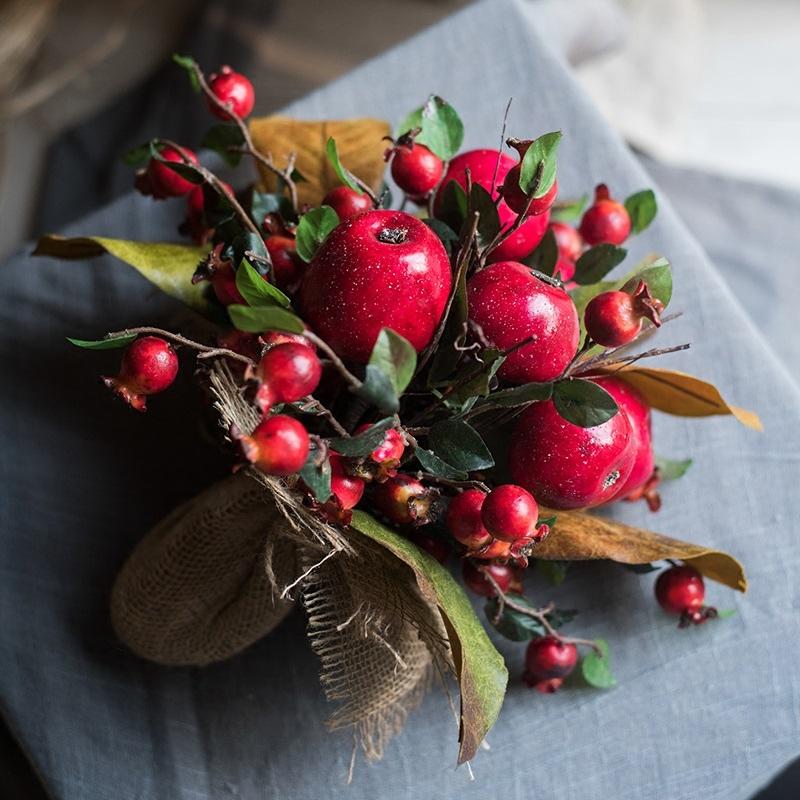 A vibrant 12-inch tall artificial bouquet featuring faux apples and pomegranates in red and green colors, perfect for home decor.