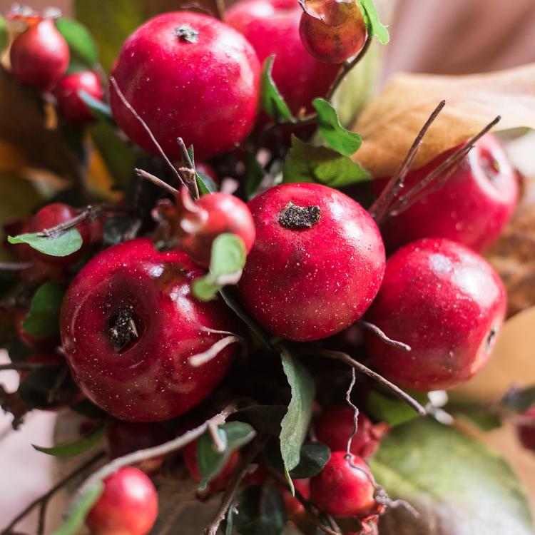 A vibrant 12-inch tall artificial bouquet featuring faux apples and pomegranates in red and green colors, perfect for home decor.