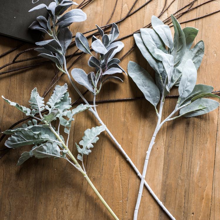 A collection of Artificial Faux Plant Wild Leaf Stems in varying heights, showcasing realistic green and gray silk leaves.