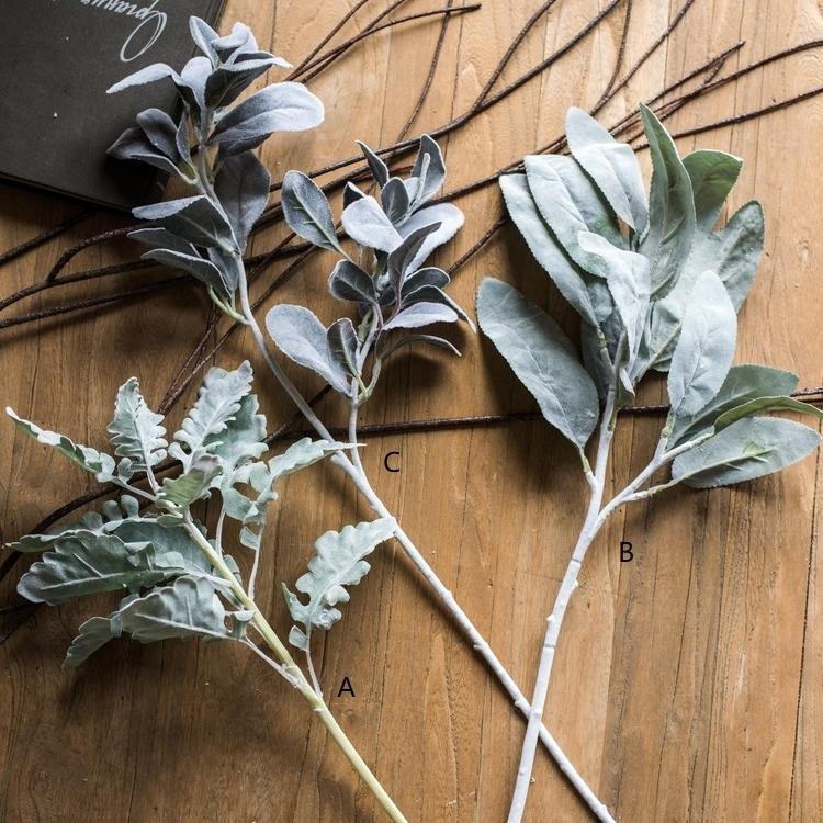 A collection of Artificial Faux Plant Wild Leaf Stems in varying heights, showcasing realistic green and gray silk leaves.