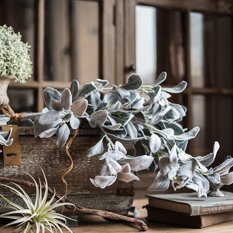 A collection of Artificial Faux Plant Wild Leaf Stems in varying heights, showcasing realistic green and gray silk leaves.