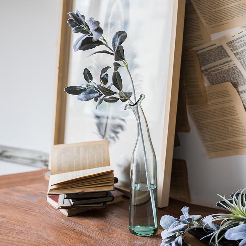 A collection of Artificial Faux Plant Wild Leaf Stems in varying heights, showcasing realistic green and gray silk leaves.