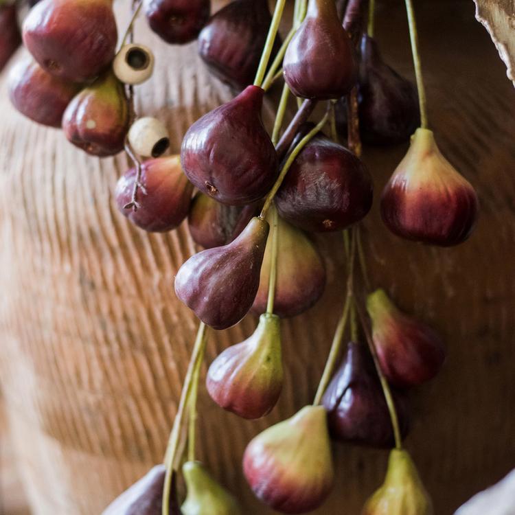 A 46-inch tall artificial fig fruit stem featuring 12 realistic figs in vibrant green and red colors, perfect for home decor.