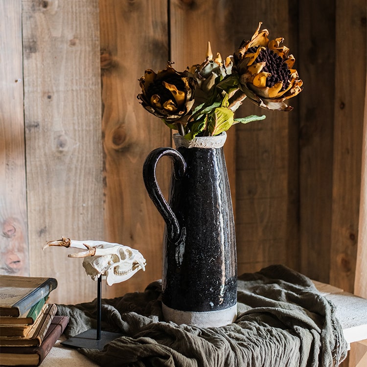 A vibrant artificial flannel sunflower stem featuring bright yellow petals and lush green leaves, perfect for home decor.