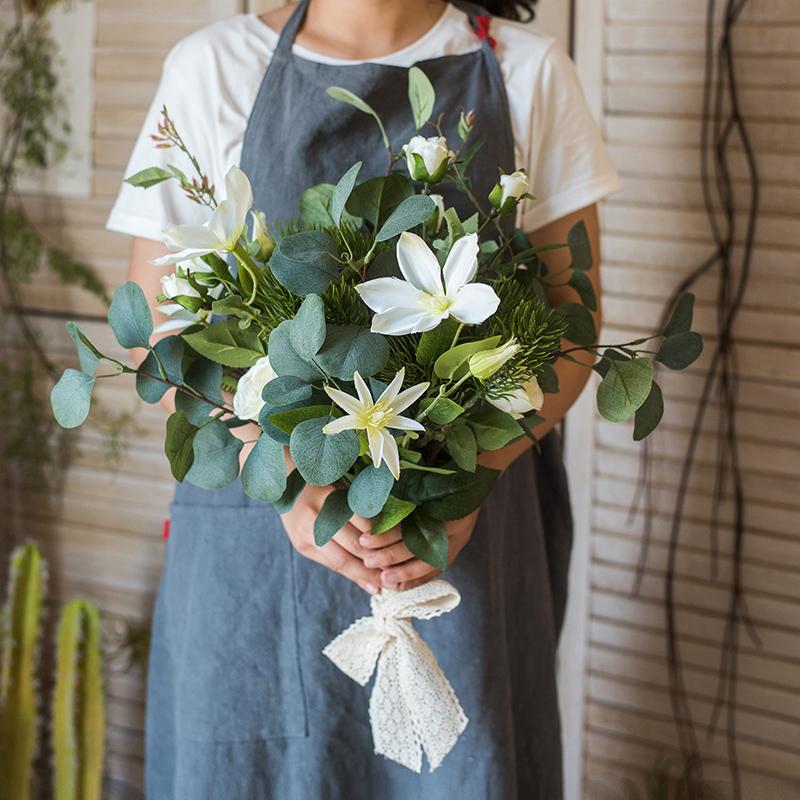 A vibrant 20-inch tall artificial flower bouquet featuring Clematis flowers and lush greenery, perfect for home decor.