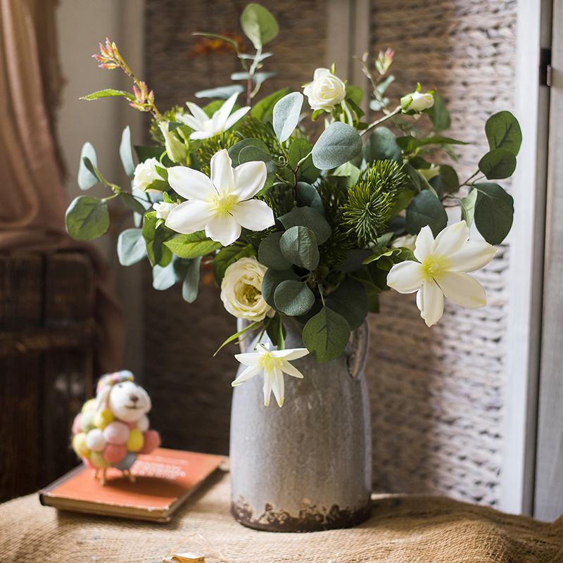 A vibrant 20-inch tall artificial flower bouquet featuring Clematis flowers and lush greenery, perfect for home decor.