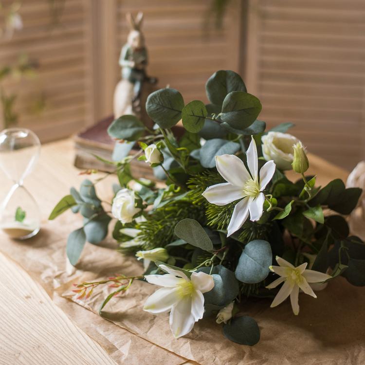 A vibrant 20-inch tall artificial flower bouquet featuring Clematis flowers and lush greenery, perfect for home decor.