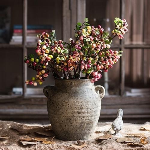 A vibrant artificial berry stem featuring yellow and red berries, standing 17 inches tall, perfect for home decor.