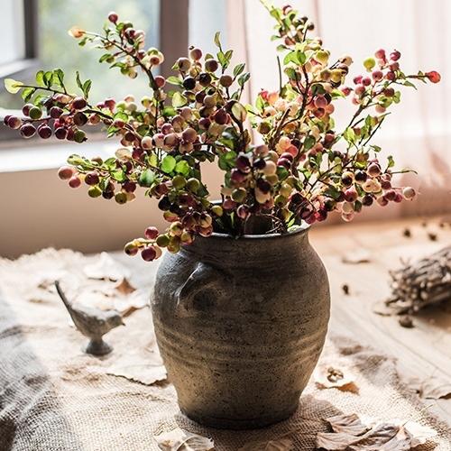 A vibrant artificial berry stem featuring yellow and red berries, standing 17 inches tall, perfect for home decor.