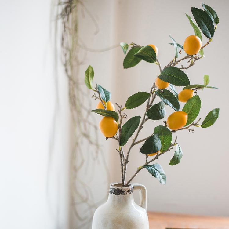 A 39-inch tall artificial lemon stem featuring eight vibrant silk lemons in green and yellow colors, perfect for home decor.