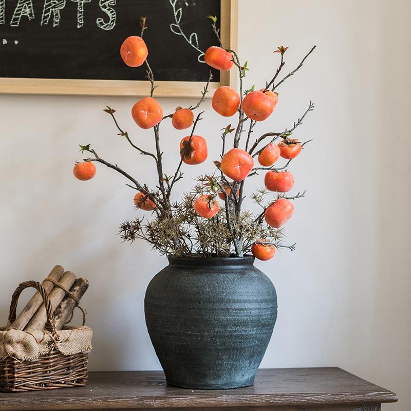 A 43-inch tall artificial fruit stem featuring six vibrant orange persimmons, perfect for home decor.