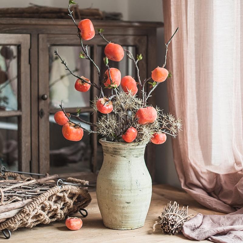 A 43-inch tall artificial fruit stem featuring six vibrant orange persimmons, perfect for home decor.