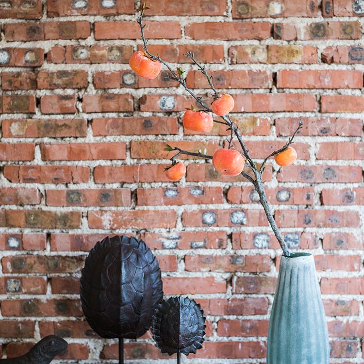 A 43-inch tall artificial fruit stem featuring six vibrant orange persimmons, perfect for home decor.