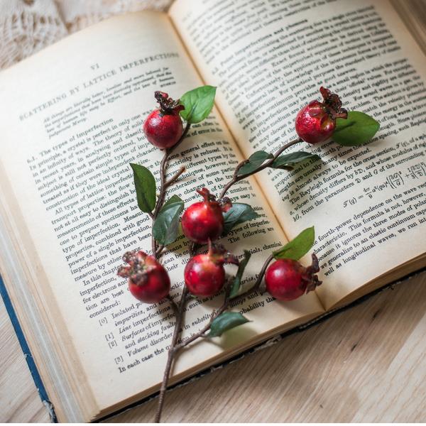 A vibrant 12-inch tall artificial pomegranate fruit bouquet featuring realistic red pomegranates and green leaves, perfect for home decor.