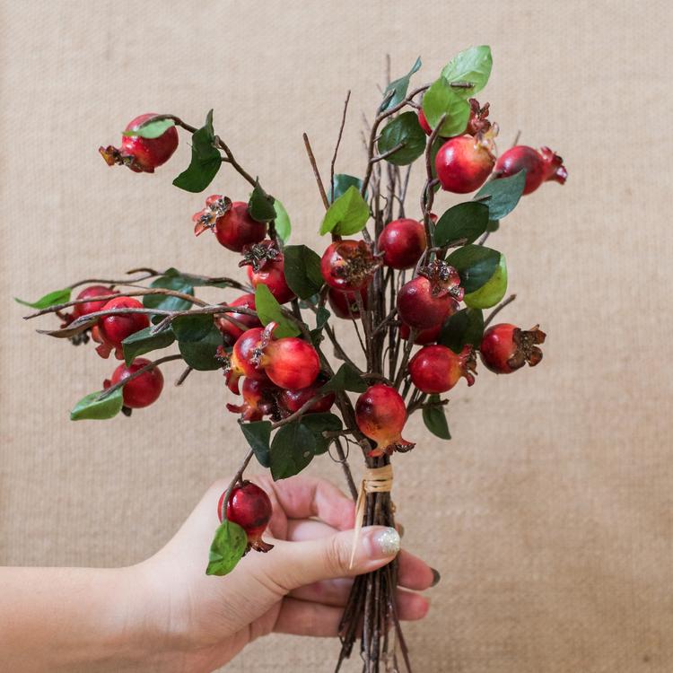 A vibrant 12-inch tall artificial pomegranate fruit bouquet featuring realistic red pomegranates and green leaves, perfect for home decor.