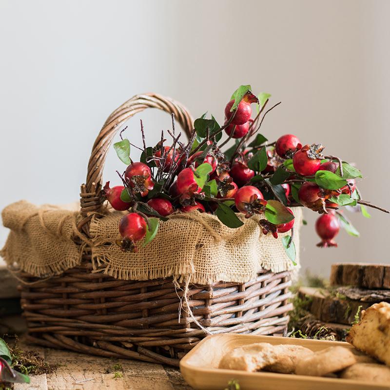 A vibrant 12-inch tall artificial pomegranate fruit bouquet featuring realistic red pomegranates and green leaves, perfect for home decor.