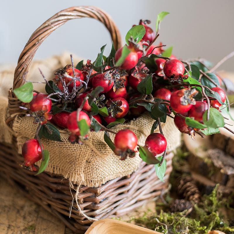 A vibrant 12-inch tall artificial pomegranate fruit bouquet featuring realistic red pomegranates and green leaves, perfect for home decor.